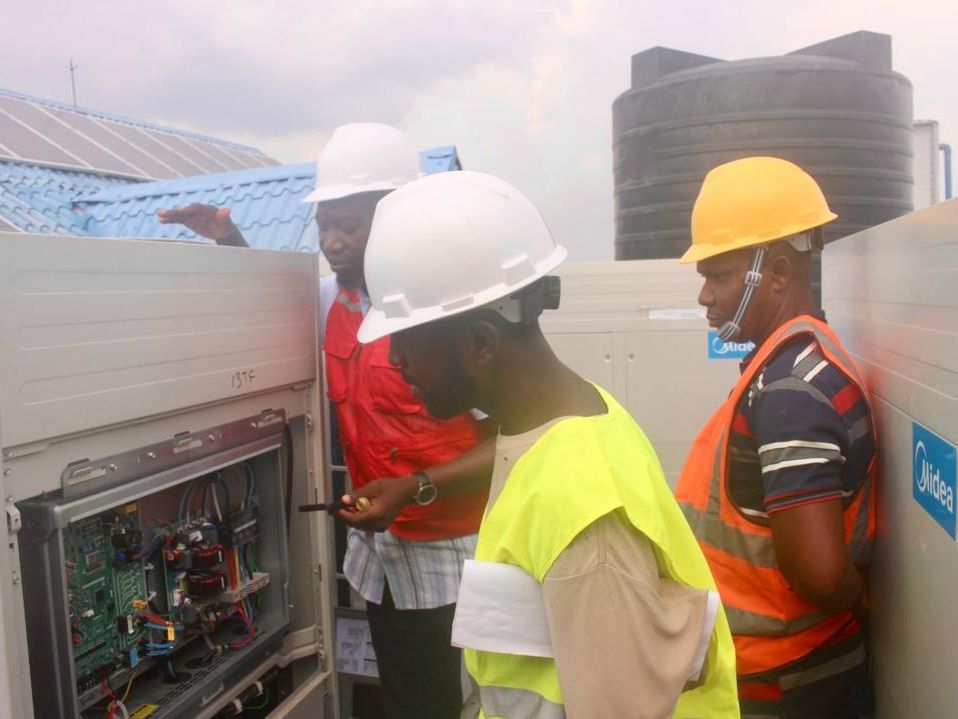 Elite Electromechanical engineers working on an open control panel